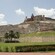 A 17th century fortress flies the Columbian flag from its position on a hill